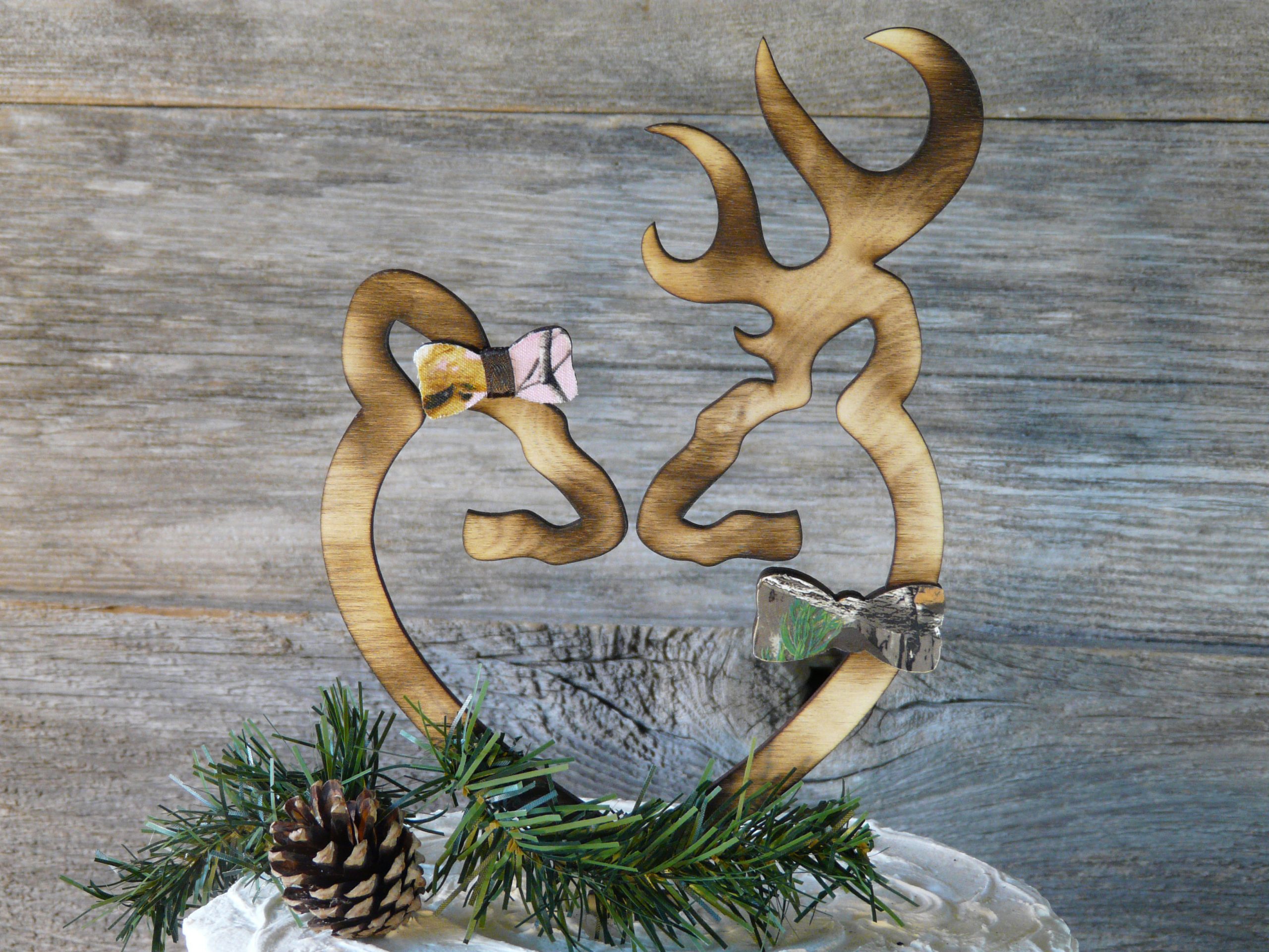 Rustic wood deer cake topper with camo bow tie and hair bow. She wears Realtree Pink and he wears original Realtree.
