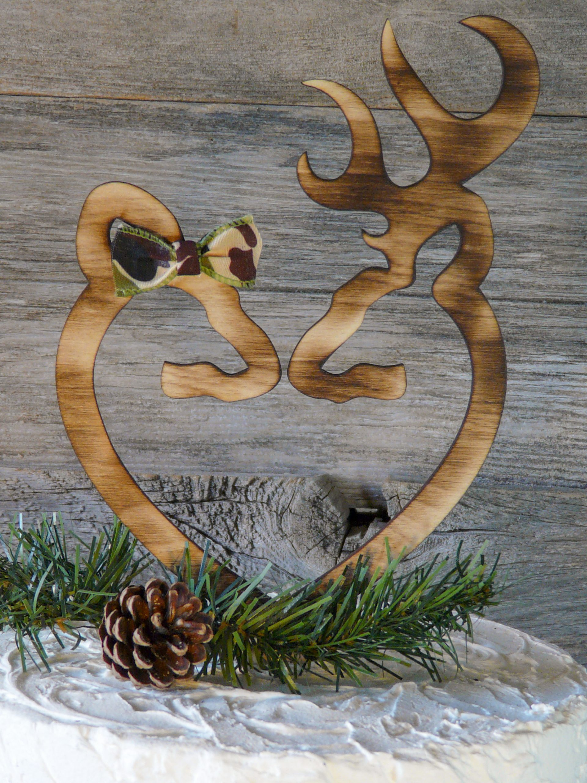 Natural wood cake topper, hand torched, with camo ribbon on female deer.